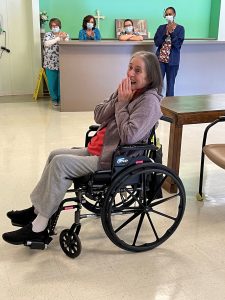 older woman in wheelchair gasps in surprise